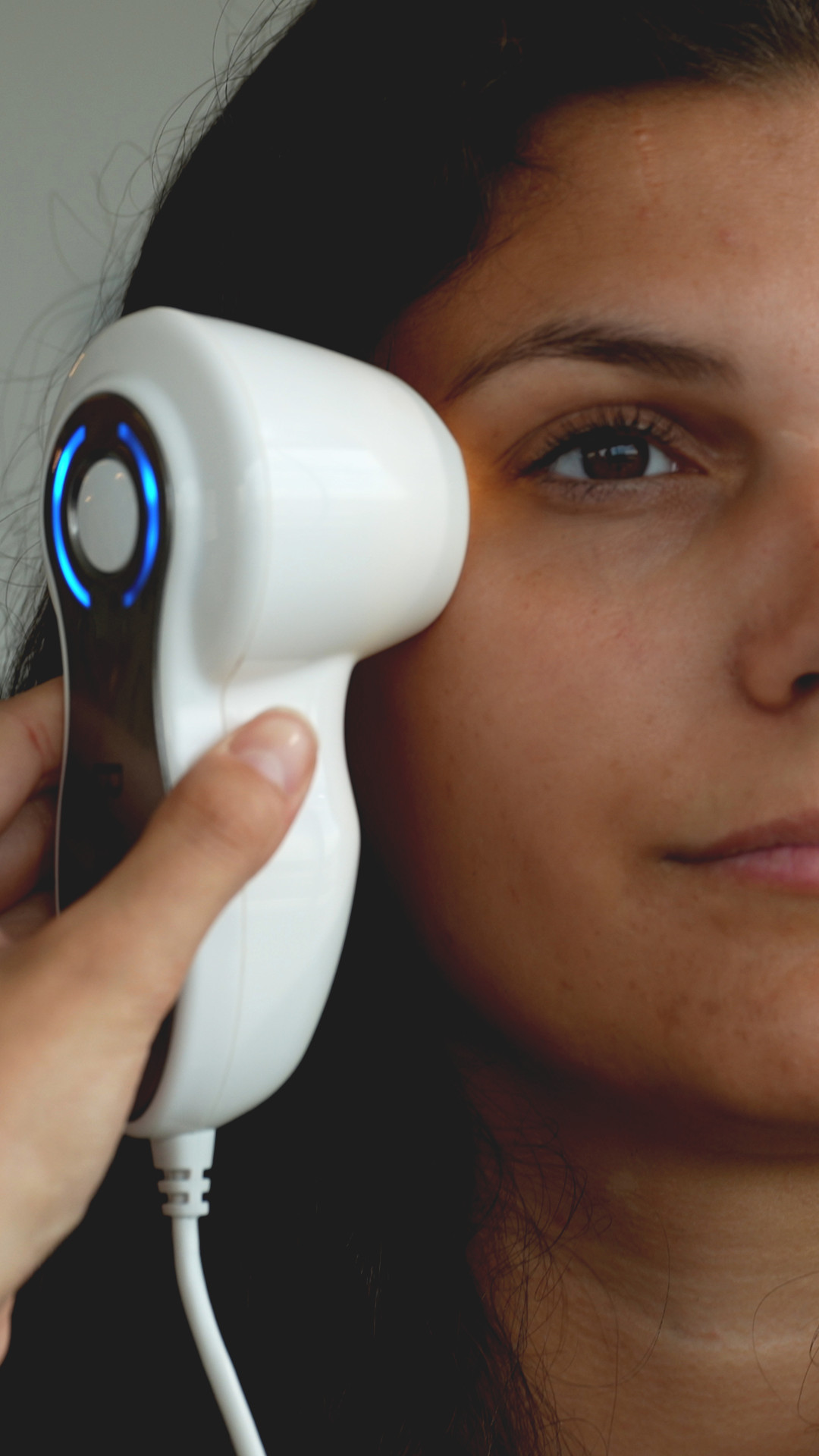 a person using a device to check the eye area